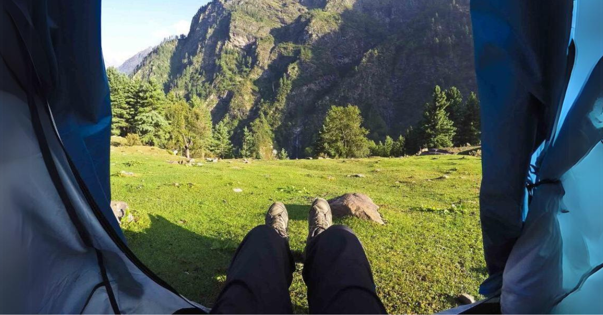 A man (Vinay) sitting at a mountaintop, watching the valley beneath