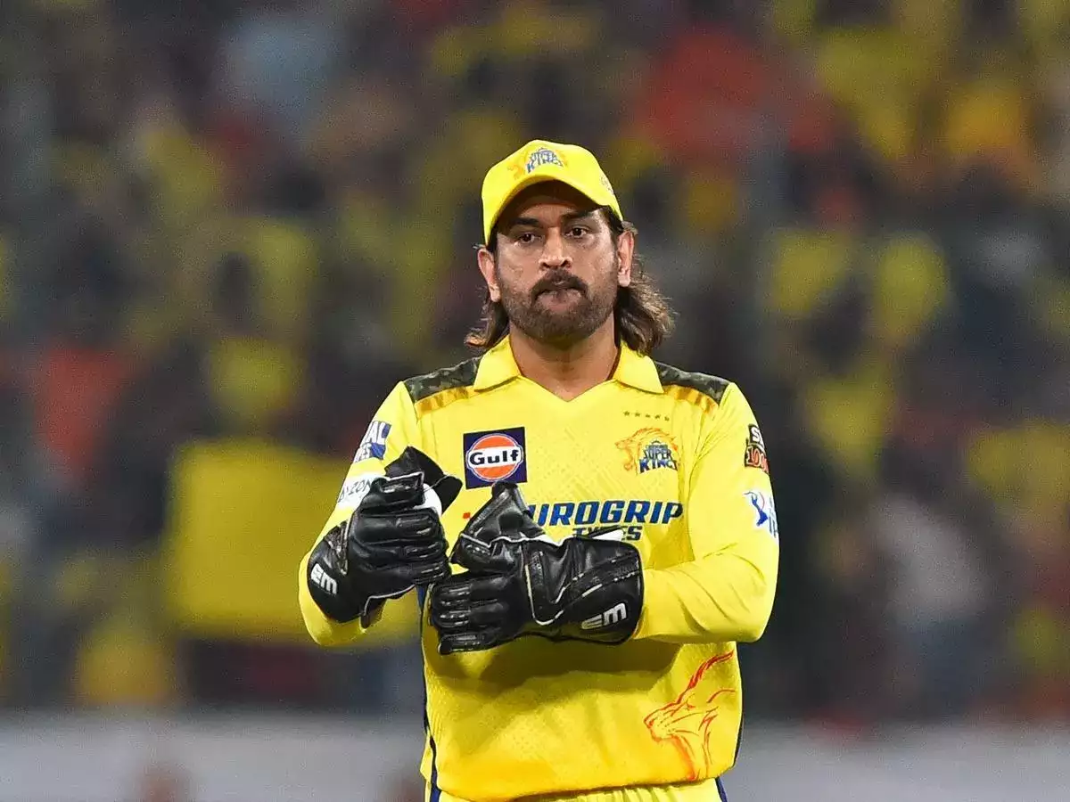 Dhoni in his IPL CSK jersey winning trophy with the team