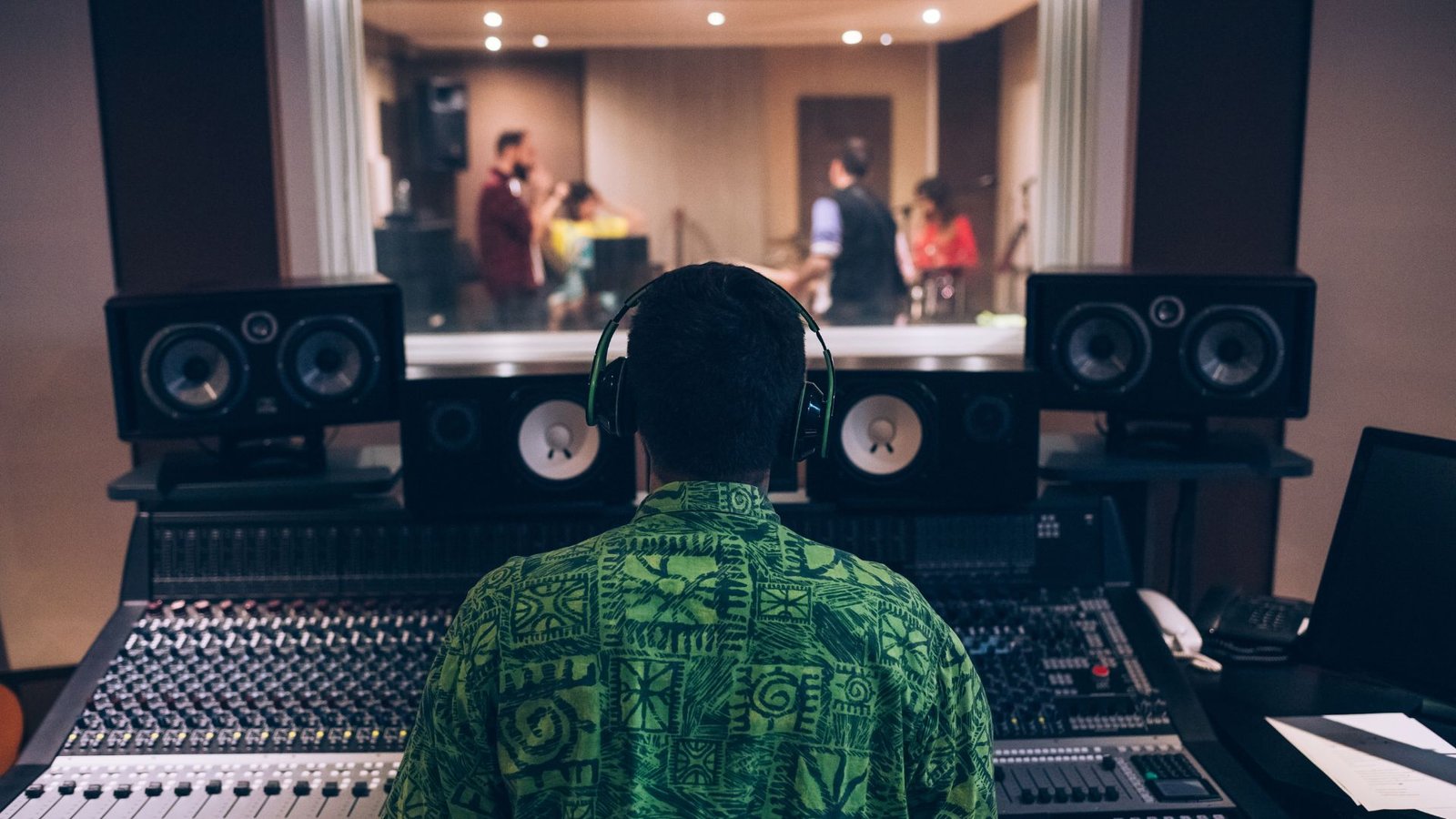 Recording studio with a controlling figure in the background