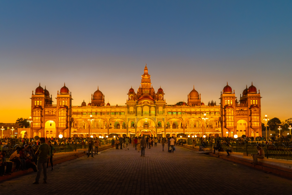 Mysore is a city steeped in rich history, culture, and architectural marvels. Renowned for its magnificent palaces, vibrant festivals, and serene gardens, Mysore offers visitors many unforgettable experiences. From exploring its royal heritage to indulging in authentic local cuisine, there's something for everyone in this enchanting city. Mysore Palace Step into the opulent world of the Wodeyar dynasty at the iconic Mysore Palace, a masterpiece of Indo-Saracenic architecture. Chamundi Hill Trek up Chamundi Hill to visit the ancient Chamundeshwari Temple and witness breathtaking views of Mysore from the top. Brindavan Gardens Spend an evening at Brindavan Gardens, where illuminated fountains dance to music against lush greenery and the Krishnaraja Sagar Dam. St. Philomena's Church Admire the Gothic-style architecture of St. Philomena's Church, known for its majestic spires and stained glass windows. Mysore Zoo Explore the diverse fauna at Mysore Zoo, home to rare species like white tigers, African elephants, and giraffes, amidst beautifully landscaped gardens. Jaganmohan Palace Step back in time at Jaganmohan Palace, housing a wonderful collection of paintings by renowned artists like Raja Ravi Varma. Devaraja Market Indulge in the vibrant atmosphere of Devaraja Market, a hotspot for shopping for traditional silk sarees, spices, sandalwood artefacts, and more. Karanji Lake Unwind amidst nature at Karanji Lake, a serene oasis within the city that offers boating facilities, a butterfly park, and a scenic walking trail. Rail Museum Learn about the history of Indian railways at the Rail Museum, featuring vintage locomotives, carriages, and interactive exhibits for train enthusiasts. Local Cuisine At popular eateries, treat your taste buds to authentic Mysore delicacies like masala dosa, Mysore Pak, idli-vada, and masala dosa. Enjoy every moment spent vacationing in the city of palaces.