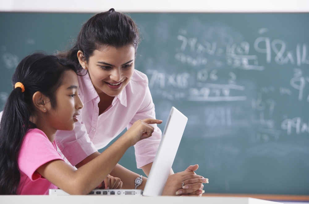 Teacher guiding students in the classroom